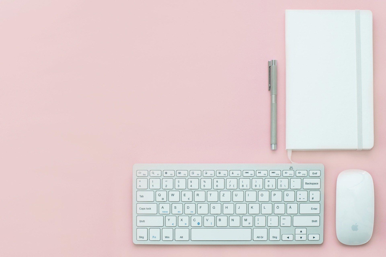 Blogging setup on a chalk pink background.